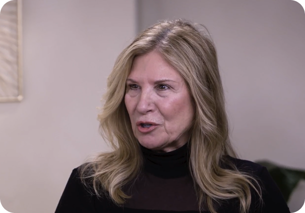 A link to a video. An older white woman with long blonde hair speaking to someone off to the right.