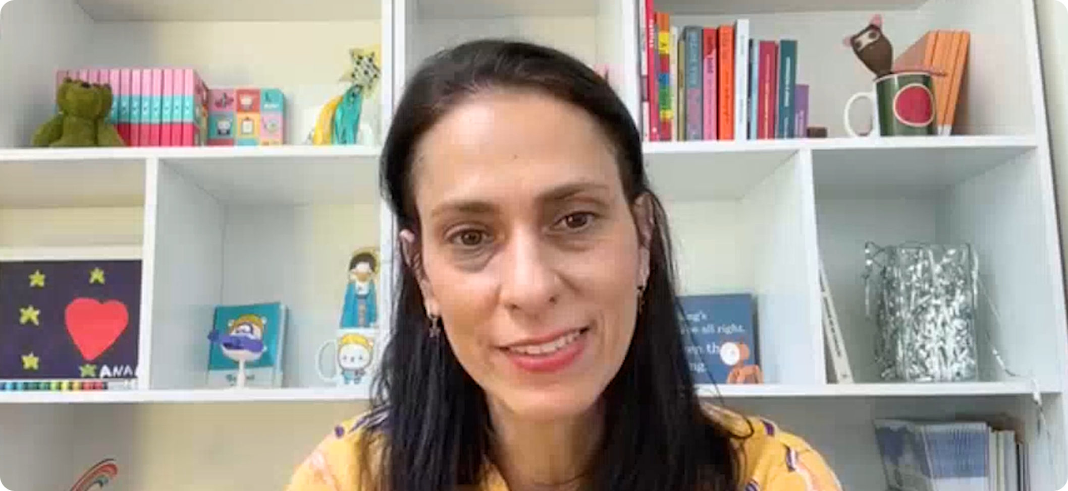 A link to a video. A middlee-aged woman with long black hair is smiling and speaking to the viewer.